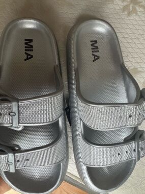 MIA Libby silver Eva Slides feature two straps with buckle closures.